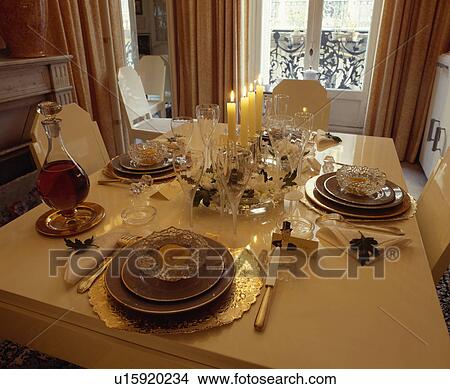 Lighted candles and place settings on table View Large Photo Image Picture - Lighted candles and place settings on table. Fotosearch