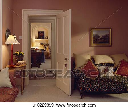 Lighted lamp beside open door in peach living room View Large Photo Image Stock Photo - Lighted lamp beside open door in peach living room. Fotosearch