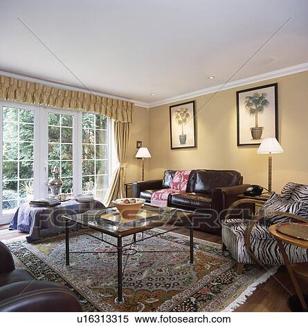 Lighted lamps on table in traditional living room with leather sofa View Large Photo Image Stock Photography - Lighted lamps on table in traditional living room with leather sofa. Fotosearch