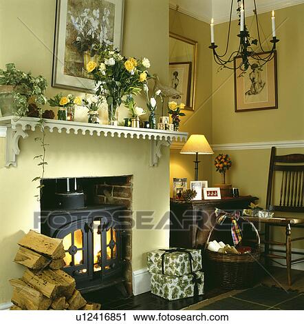 Logs beside stove in traditional cream living room View Large Photo Image Stock Image - Logs beside stove in traditional cream living room. Fotosearch