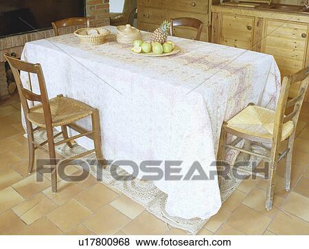 Long white cloth on rectangular table in dining room with rush-seated chairs View Large Photo Image Stock Photo - Long white cloth on rectangular table in dining room with rush-seated chairs. Fotosearch