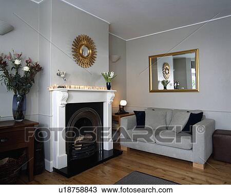 Mirror above fireplace in traditional living room View Large Photo Image Stock Image - Mirror above fireplace in traditional living room. Fotosearch