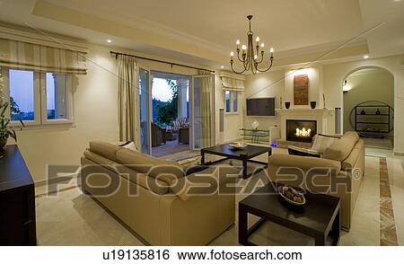 Modern apartment livingroom with beige leather sofas and view of the terrace through open glass doors View Large Photo Image Stock Photograph - Modern apartment livingroom with beige leather sofas and view of the terrace through open glass doors. Fotosearch