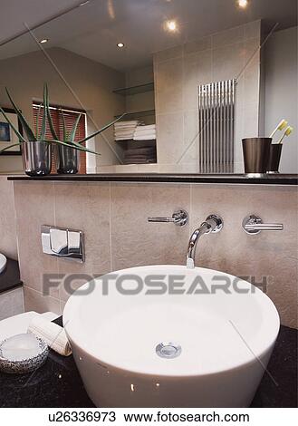 Modern bathroom with white basin and mirrored wall View Large Photo Image Stock Image - Modern bathroom with white basin and mirrored wall. Fotosearch