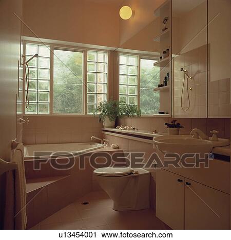 Modern beige bathroom with corner bath View Large Photo Image Stock Image - Modern beige bathroom with corner bath. Fotosearch