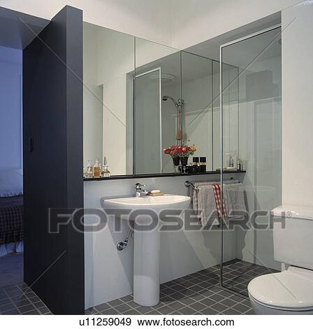 Modern grey and white mirrored shower room View Large Photo Image Stock Photo - Modern grey and white mirrored shower room. Fotosearch