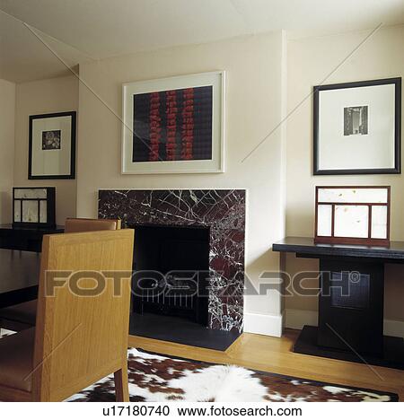 Modern Picture Above Black Marble Fireplace In Modern Dining Room