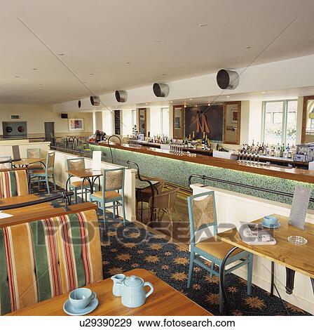 Modern restaurant dining room with long bar View Large Photo Image Stock Photo - Modern restaurant dining room with long bar. Fotosearch