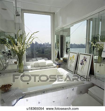 Modern tiled whirlpool bath overlooking the city View Large Photo Image Picture - Modern tiled whirlpool bath overlooking the city . Fotosearch