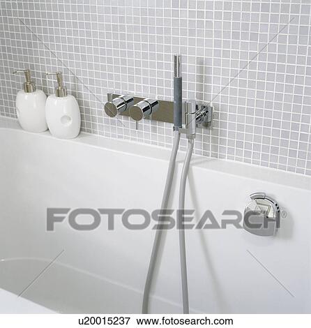 Modern white bath with chrome showerhead and taps View Large Photo Image Stock Photo - Modern white bath with chrome showerhead and taps . Fotosearch