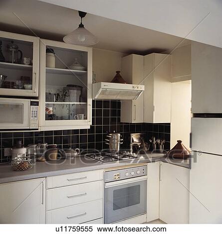 Modern white spacesaving kitchen with grey worktops and oven View Large Photo Image Stock Photography - Modern white spacesaving kitchen with grey worktops and oven. Fotosearch
