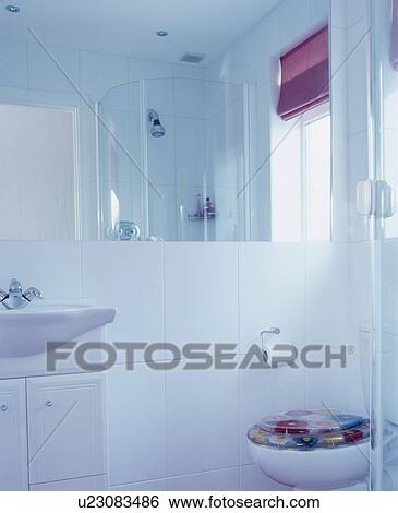 Modern white tiled bathroom with glass corner shower and pink blind View Large Photo Image Stock Photograph - Modern white tiled bathroom with glass corner shower and pink blind. Fotosearch