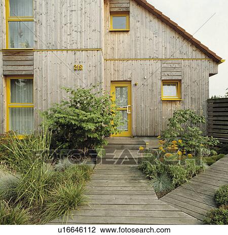 Modern wood-cladl town house with decking path View Large Photo Image Stock Image - Modern wood-cladl town house with decking path. Fotosearch