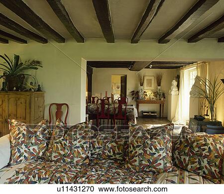Multi-coloured cushions on sofa in cottage living room View Large Photo Image Stock Image - Multi-coloured cushions on sofa in cottage living room. Fotosearch