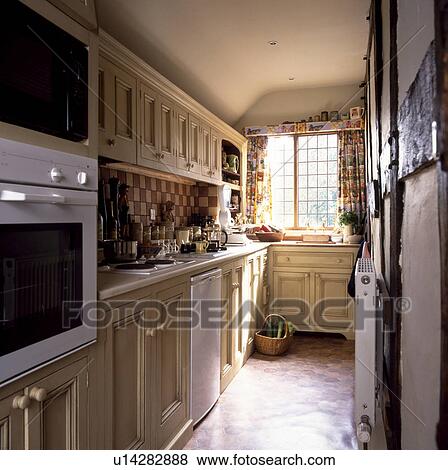 Narrow galley kitchen extension with wooden units View Large Photo Image Stock Photo - Narrow galley kitchen extension with wooden units . Fotosearch