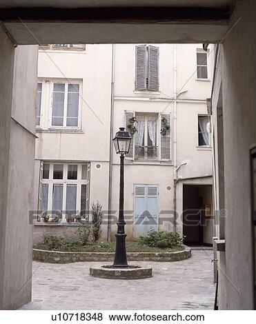 Old lamp in courtyard of traditional house in Paris View Large Photo Image Stock Photo - Old lamp in courtyard of traditional house in Paris. Fotosearch
