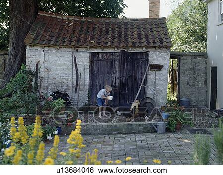 Open door into small glass greenhouse extension View Large Photo Image Stock Photograph - Open door into small glass greenhouse extension. Fotosearch
