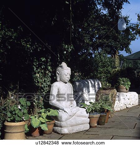 Oriental statue in country garden View Large Photo Image Stock Photo - Oriental statue in country garden. Fotosearch
