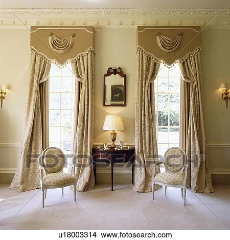 Picture - Ornate pelmets above cream curtains in traditional drawing room&#13; &#10; &#13; &#10; &#13; &#10; &#13; &#10; &#13; &#10; &#13; &#10;. Fotosearch