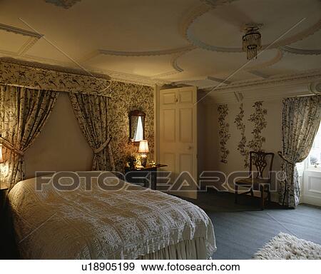 Ornate Plasterwork Ceiling In Traditional Bedroom With Patterned