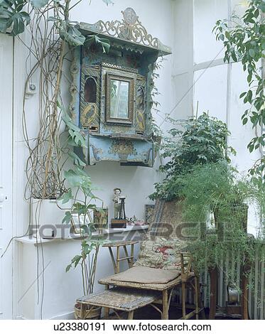 Painted antique wall cabinet and cane chaiselongue View Large Photo Image Stock Image - Painted antique wall cabinet and cane chaiselongue. Fotosearch