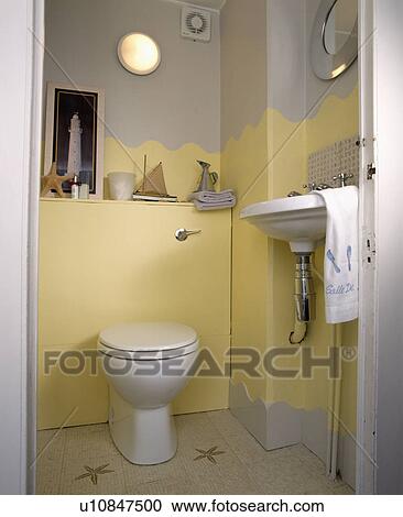 Stock Image - Pale yellow cloakroom with white fittings. Fotosearch