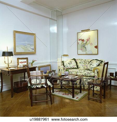 Stock Image - Parquet floor in traditional living room with floral sofa. Fotosearch