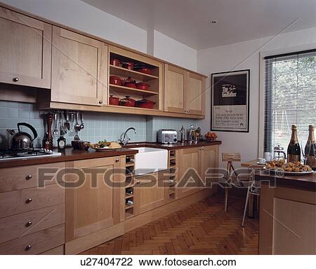 Parquet flooring in modern white kitchen with pale wood fitted cupboards and pastel blue wall tiles View Large Photo Image Stock Image - Parquet flooring in modern white kitchen with pale wood fitted cupboards and pastel blue wall tiles. Fotosearch