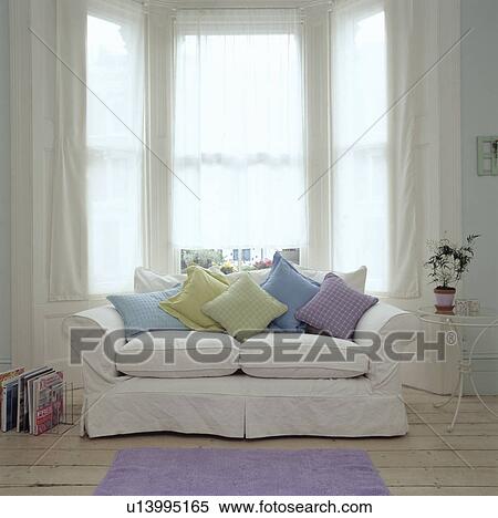 Pastel cushions on white sofa in modern living room View Large Photo Image Stock Photography - Pastel cushions on white sofa in modern living room. Fotosearch