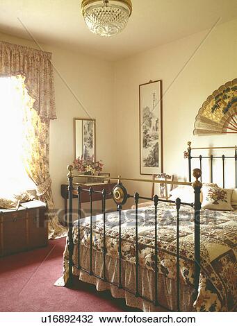 Patchwork quilt on antique brass bed in country bedroom View Large Photo Image Stock Image - Patchwork quilt on antique brass bed in country bedroom. Fotosearch