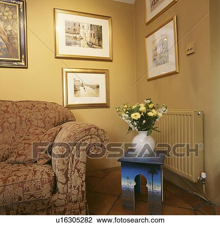 Patterned sofa and small painted trompe l'oeil table corner of yellow living room View Large Photo Image Stock Image - Patterned sofa and small painted trompe l'oeil table corner of yellow living room. Fotosearch