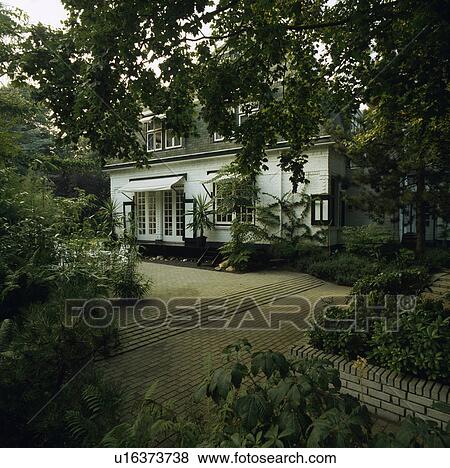 Paved patio in front of large white country house View Large Photo Image Stock Photo - Paved patio in front of large white country house. Fotosearch