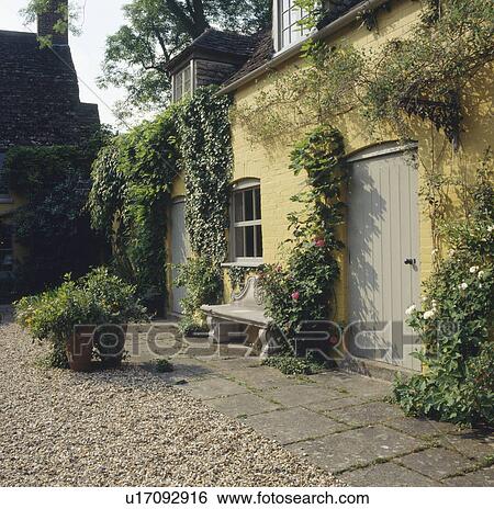 Paving and gravel courtyard in front of pale yellow country house View Large Photo Image Stock Photograph - Paving and gravel courtyard in front of pale yellow country house. Fotosearch