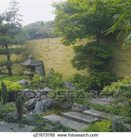 Paving slabs across small stream in oriental-style garden with high yellow brick wall View Large Photo Image Stock Photography - Paving slabs across small stream in oriental-style garden with high yellow brick wall. Fotosearch