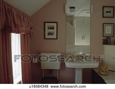 Peach bathroom with toning curtains and mirror above white pedestal basin View Large Photo Image Stock Photo - Peach bathroom with toning curtains and mirror above white pedestal basin. Fotosearch