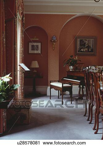 Piano and grey carpet in terracotta red country dining room with alcoves View Large Photo Image Stock Image - Piano and grey carpet in terracotta red country dining room with alcoves. Fotosearch
