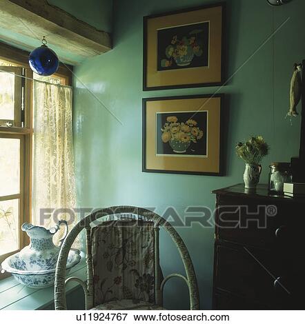 Pictures on wall beside window in pastel turquoise cottage bedroom View Large Photo Image Stock Photo - Pictures on wall beside window in pastel turquoise cottage bedroom. Fotosearch