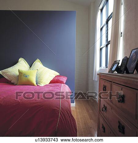 Stock Image - Pink bed cover in room. Fotosearch