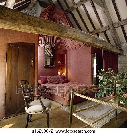 Pink fabric walls and drapes and matching bedlinen in small openplan bedroom in barn converesion View Large Photo Image Stock Image - Pink fabric walls and drapes and matching bedlinen in small openplan bedroom in barn converesion. Fotosearch
