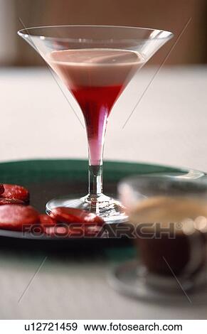 Stock Photo - Pink frothy cocktail in elegant glass with chocolate discs.. Fotosearch