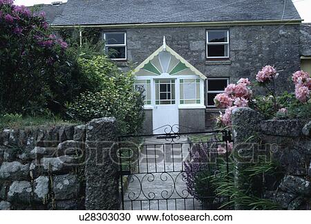 Pink hydrangeas on wall beside gate on garden in front of stone cottage with Victorian glass porch View Large Photo Image Stock Image - Pink hydrangeas on wall beside gate on garden in front of stone cottage with Victorian glass porch. Fotosearch