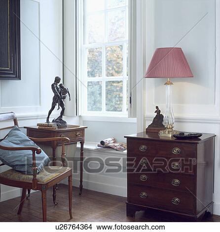 Pink lamp on antique chest-of-drawers in traditional living room View Large Photo Image Picture - Pink lamp on antique chest-of-drawers in traditional living room . Fotosearch