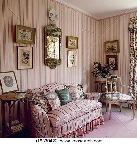 Pink striped Colefax+Fowler sofa with matching wallpaper in traditional pink bedroom View Large Photo Image Stock Image - Pink striped Colefax+Fowler sofa with matching wallpaper in traditional pink bedroom. Fotosearch