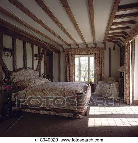 PinkToile de Jouy French bed and linen in beamed country bedroom with sunlight streaming onto floor View Large Photo Image Stock Image - PinkToile de Jouy French bed and linen in beamed country bedroom with sunlight streaming onto floor. Fotosearch