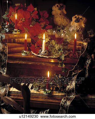 Poinsettias and candles on piano in traditional living room View Large Photo Image Stock Image - Poinsettias and candles on piano in traditional living room. Fotosearch