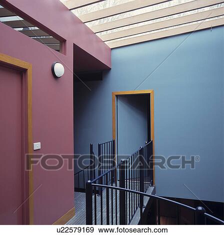 Stock Photo - Purple and blue modern landing with black metal bannisters. Fotosearch