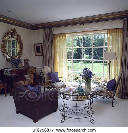 Purple armchair and metal table in country living room View Large Photo Image Stock Photo - Purple armchair and metal table in country living room. Fotosearch
