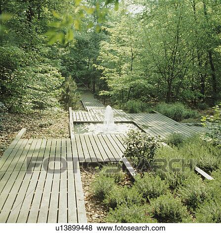 Rectangular pond and decking in country garden in summer View Large Photo Image Stock Photo - Rectangular pond and decking in country garden in summer. Fotosearch