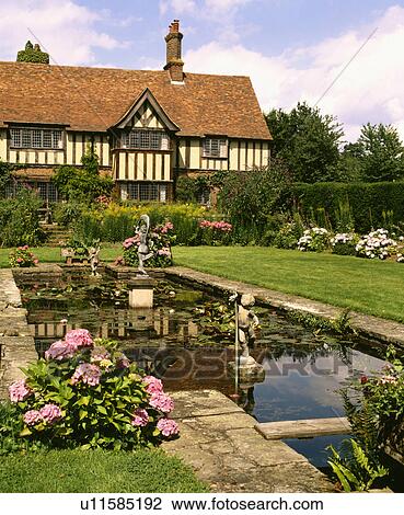 Rectangular pond in garden in front of large country house in summer View Large Photo Image Stock Image - Rectangular pond in garden in front of large country house in summer. Fotosearch