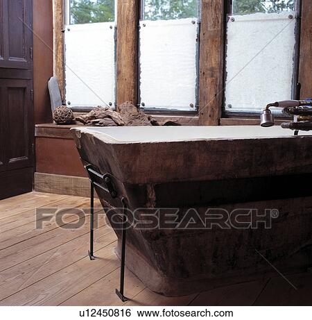 Recycling bath with wooden surround in rustic bathroom with reclaimed wooden floorboards View Large Photo Image Stock Photograph - Recycling bath with wooden surround in rustic bathroom with reclaimed wooden floorboards. Fotosearch